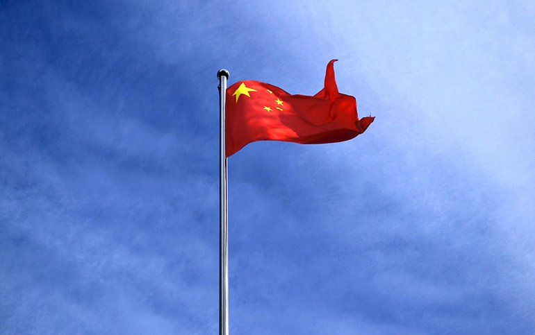 Chinesische Flagge am blauen Himmel